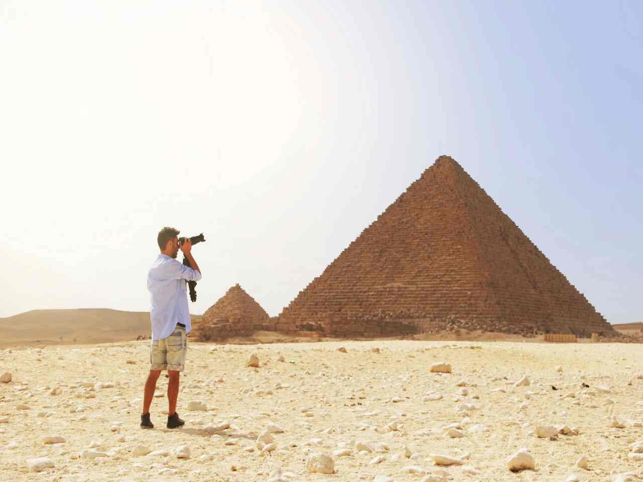 Explore the world, a man clicking the pic of Egyptian Pyramid