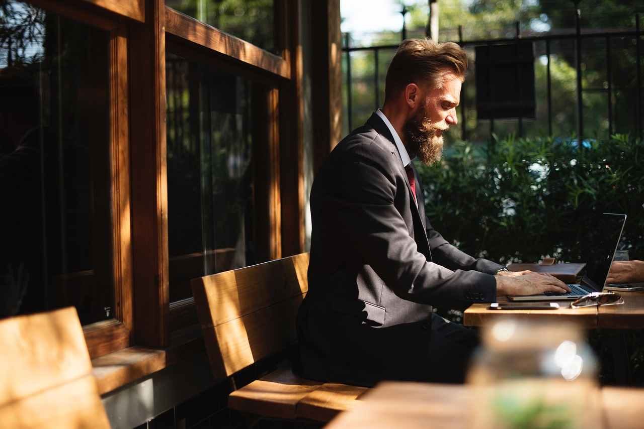 A Boss is doing his work by sitting on a sofa