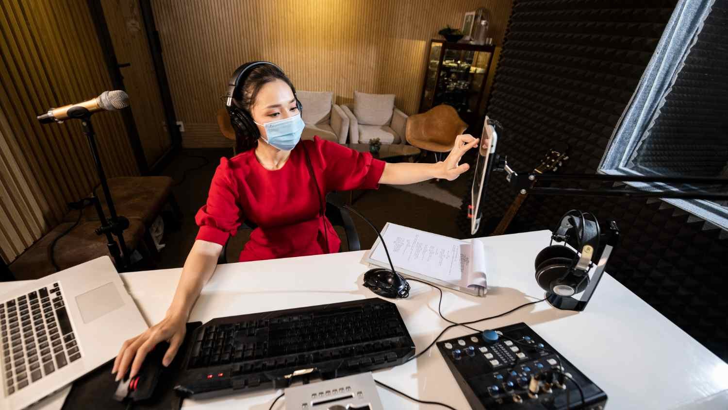 A lady is managing technical part of a podcast