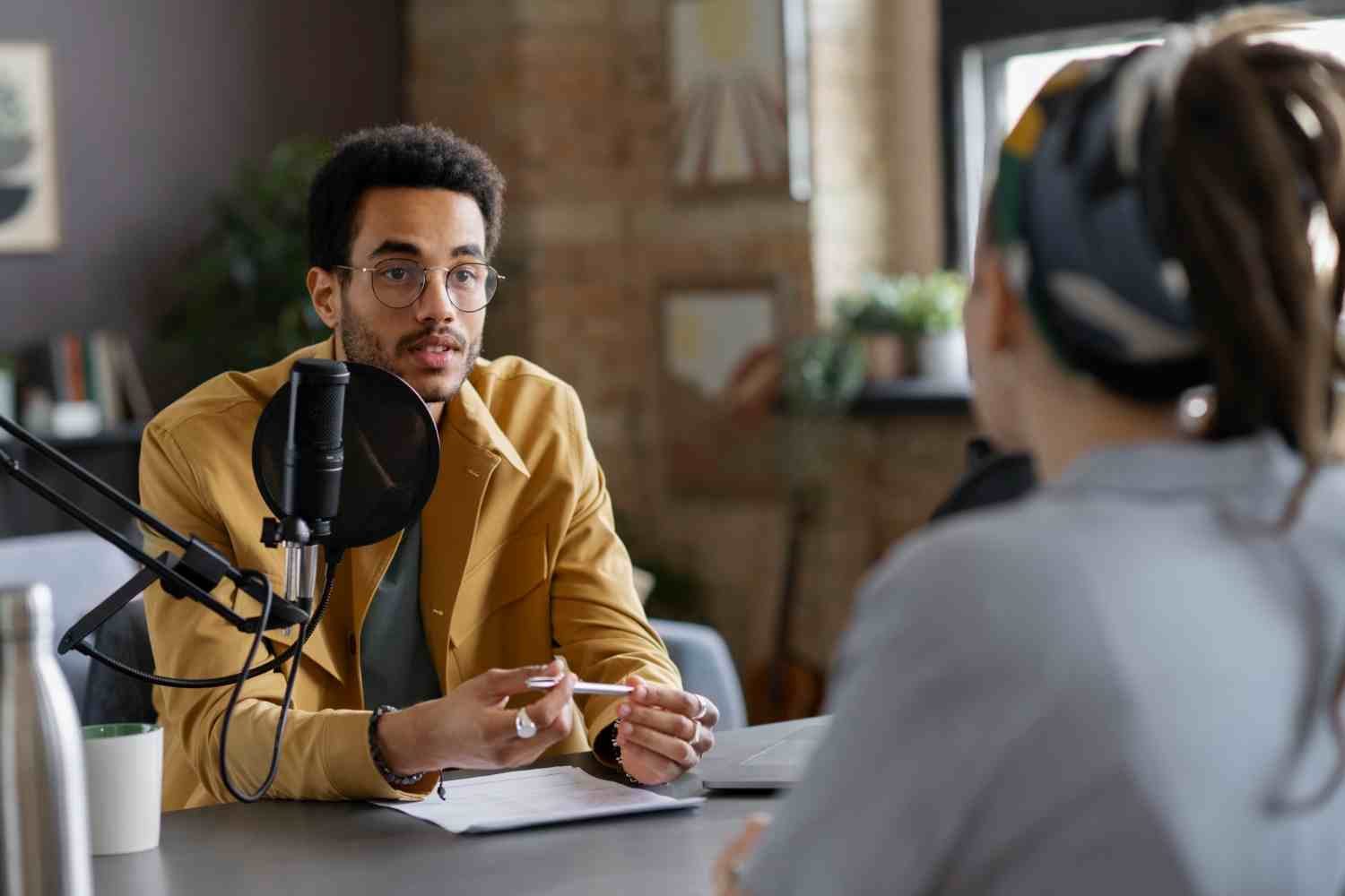 Person is in front of a mic & speaking